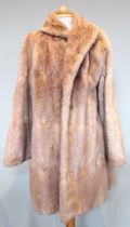 A silver mink coat, hip length, labelled 'Corbett couture' to interior, along with a short blond