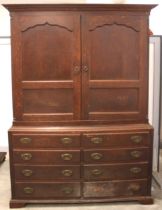 A George III oak linen press, the moulded dentil cornice over a pair of ogee panelled cupboard