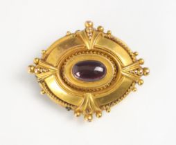A Victorian style yellow metal and untested garnet brooch, the oval shaped brooch with spherical