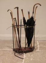 A collection of walking sticks, canes and parasols to a Victorian brass stick stand, to include;
