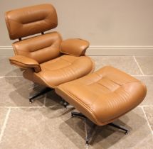Manner of Charles and Ray Eames for Herman Miller: a tan leather revolving lounge chair with