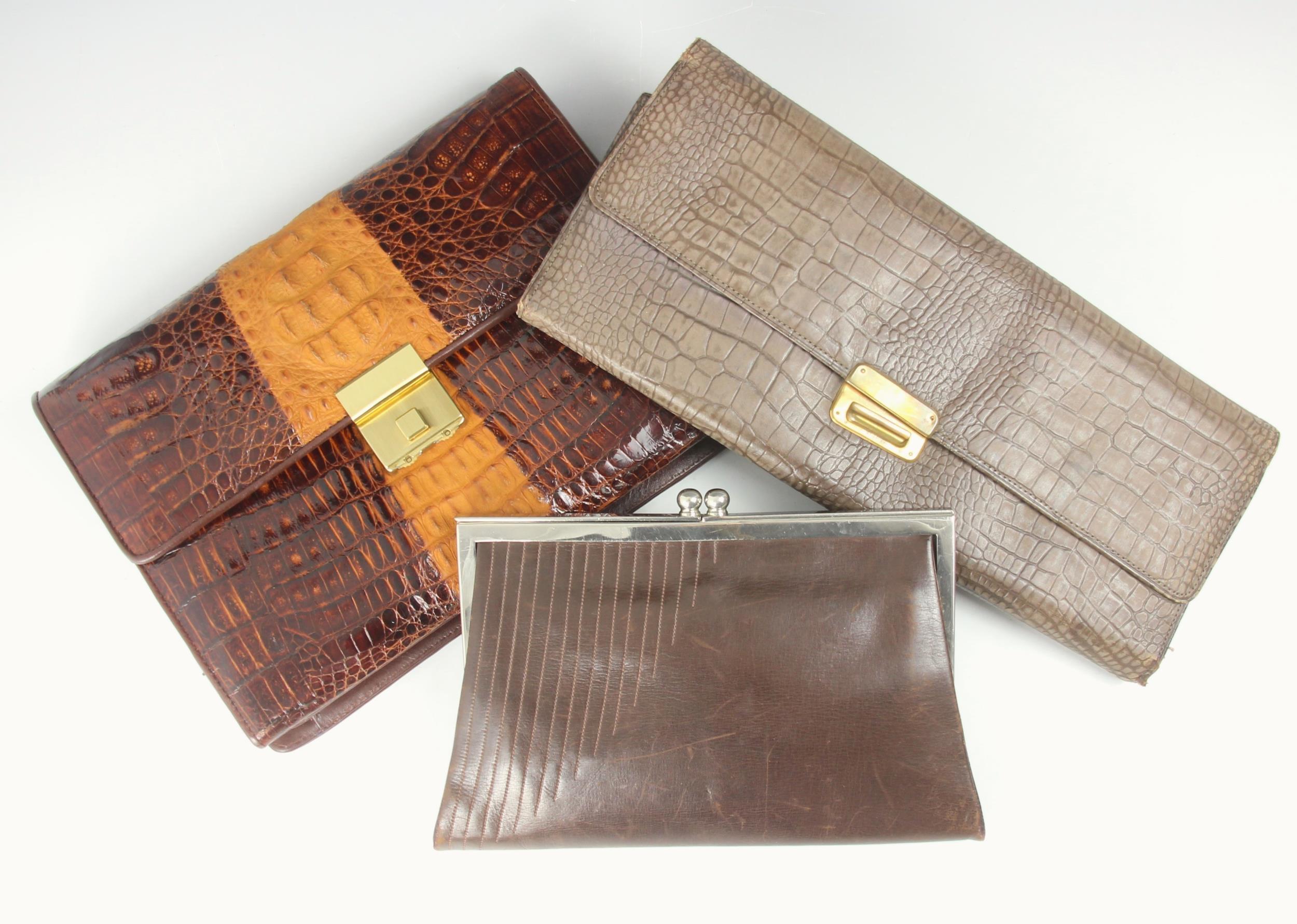 A 1930s brown leather clutch bag, white metal frame, with integral purses, a later clutch bag,
