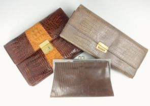 A 1930s brown leather clutch bag, white metal frame, with integral purses, a later clutch bag,