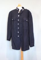 A navy blue wool Cumbria Constabulary policeman’s tunic, approximately 40’’ chest (102cm) with