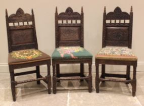 A trio of carved oak hall/side chairs in the 17th century style, late 19th century, each with