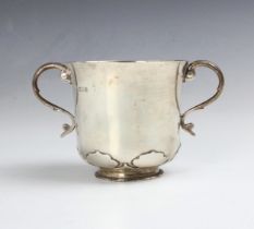 A George V silver twin handled cup, D & J Wellby Ltd, London 1911, the scroll handles above flared