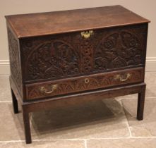 An 18th century and later carved oak mule chest, the profusely carved chest with a hinged cover