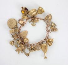 A yellow metal charm bracelet, the rose gold bracelet stamped '9.375' suspending twenty one yellow