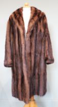 A mink dyed musquash coat, three quarter length, brown satin lining, together with a further cream