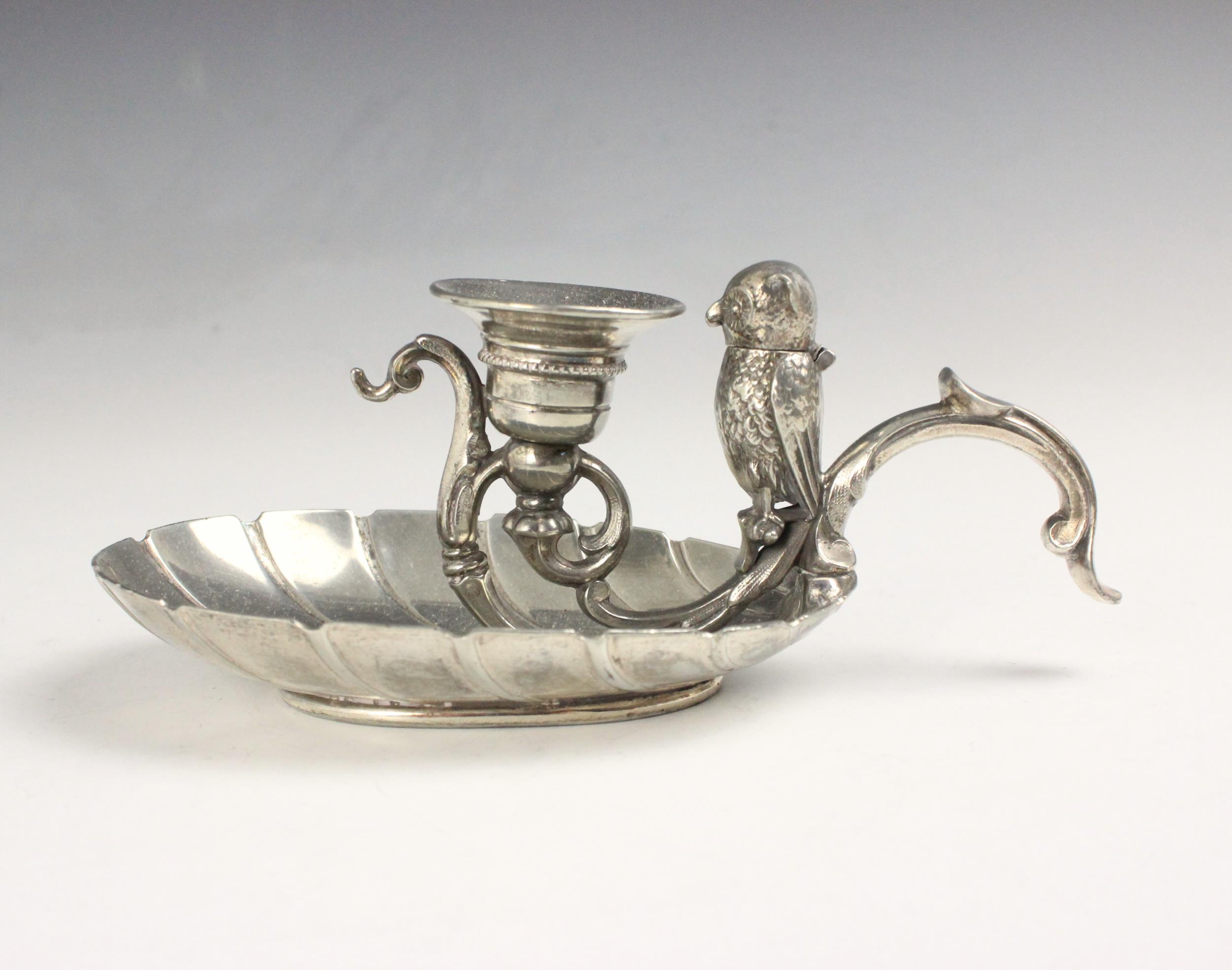 A silver plated novelty chamberstick, the scroll handle with owl shaped vesta with hinged head,