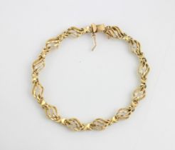 A yellow metal bracelet, the twelve openwork lozenge shaped links with engraved detail, box and