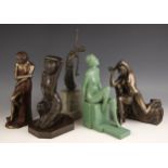 An Art Deco style bronze patinated spelter figure modelled as a kneeling dancer in the manner of