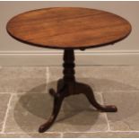 A George III oak tripod table, the circular tilt top upon a turned and tapering column extending