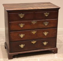 An early 18th century oak chest of drawers, the twin plank moulded top over an arrangement of two