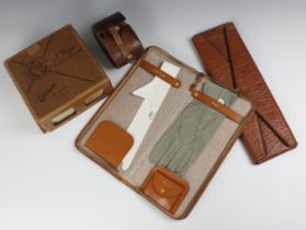 A 1940s tan leather collar and tie travelling case, containing a pair of doe skin gloves, and a CC41