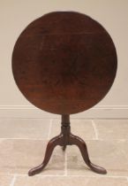 A George III mahogany tripod table, the circular top upon a bird cage mechanism and a ring turned