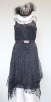 A mid 1920s black lace evening dress, lined with crepe de shine, with handkerchief hem, with