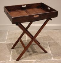 A 19th century mahogany butlers tray, the hinged gallery tray upon an associated folding 'X' frame