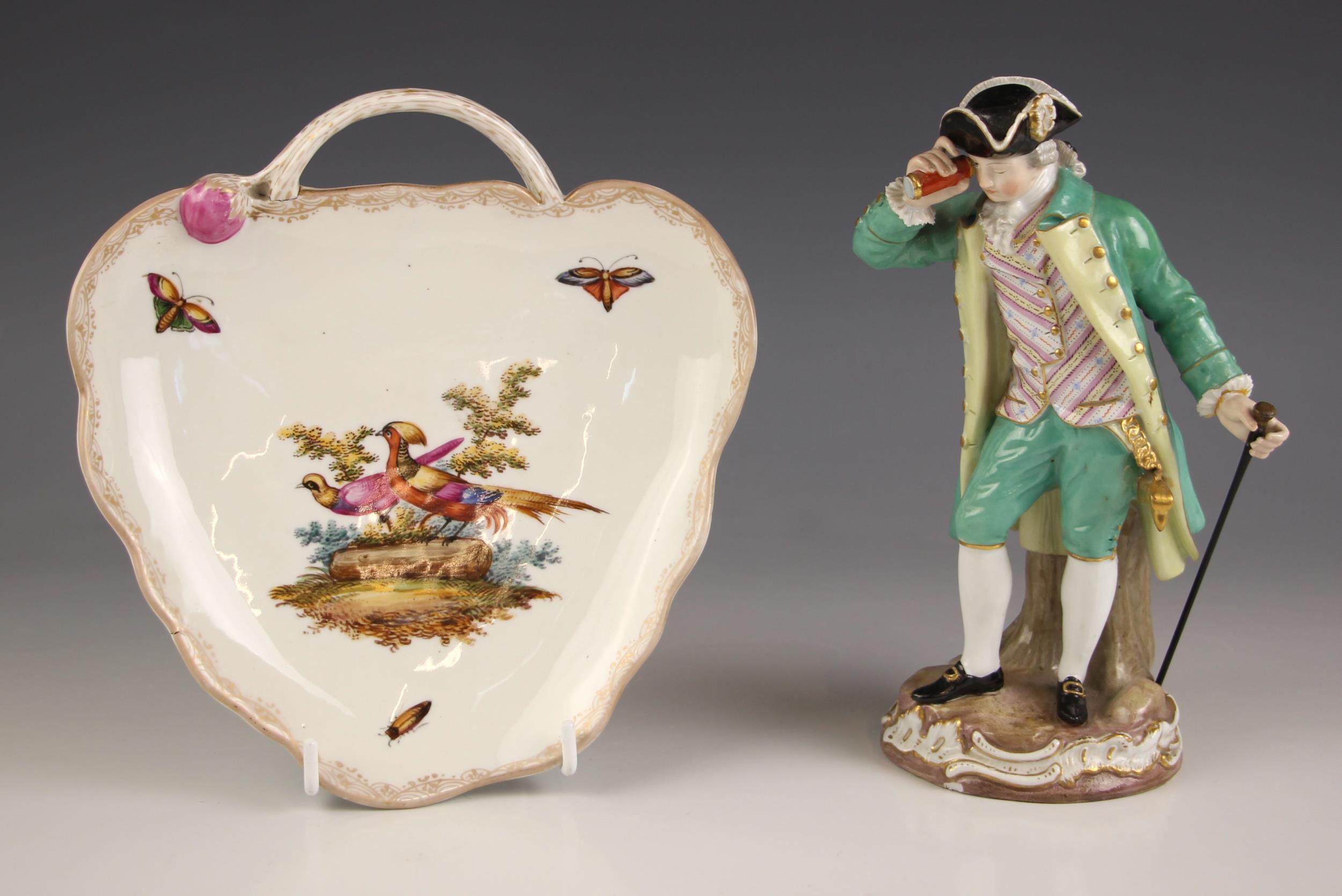 A Meissen figure, 19th century, of a gentleman with tri-corn hat, turquoise overcoat and breeches