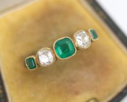 An early 20th century untested emerald and diamond ring, the three untested graduated emeralds