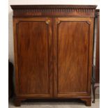 A George III mahogany wardrobe, probably Channel Islands, circa 1800, the moulded cornice with