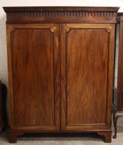 A George III mahogany wardrobe, probably Channel Islands, circa 1800, the moulded cornice with