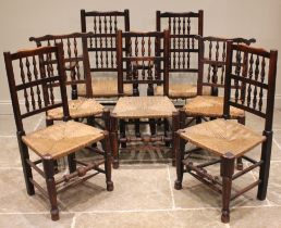 A harlequin set of seven ash spindle back and rush seated chairs, early 19th century, each with