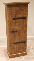 A rustic pine hall cabinet, late 20th century, the lancet shaped door applied with iron strap hinges