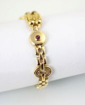 A yellow metal untested ruby and diamond bracelet, the untested cabochon ruby set in yellow metal