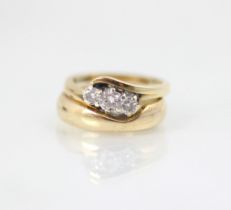 A 9ct yellow gold bespoke diamond ring, the central round cut diamond with smaller diamond to each