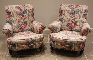 A near pair of deep-seated armchairs, in the manner of Howard & Sons, late 19th/early 20th