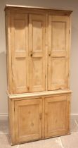 A Victorian and later pine housekeepers cupboard, the moulded cornice over three panelled doors