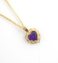 A yellow metal and untested amethyst set pendant, the heart shaped untested amethyst within openwork