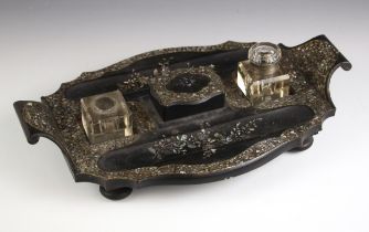 An Aesthetic Movement ebonised papier mache partners' desk stand, late 19th century, the pen wells