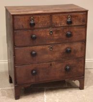 A George III oak chest of drawers, formed with an arrangement of two short and three graduated