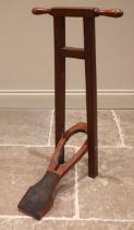 A free standing mahogany boot jack, early 20th century, with turned handles upon the square