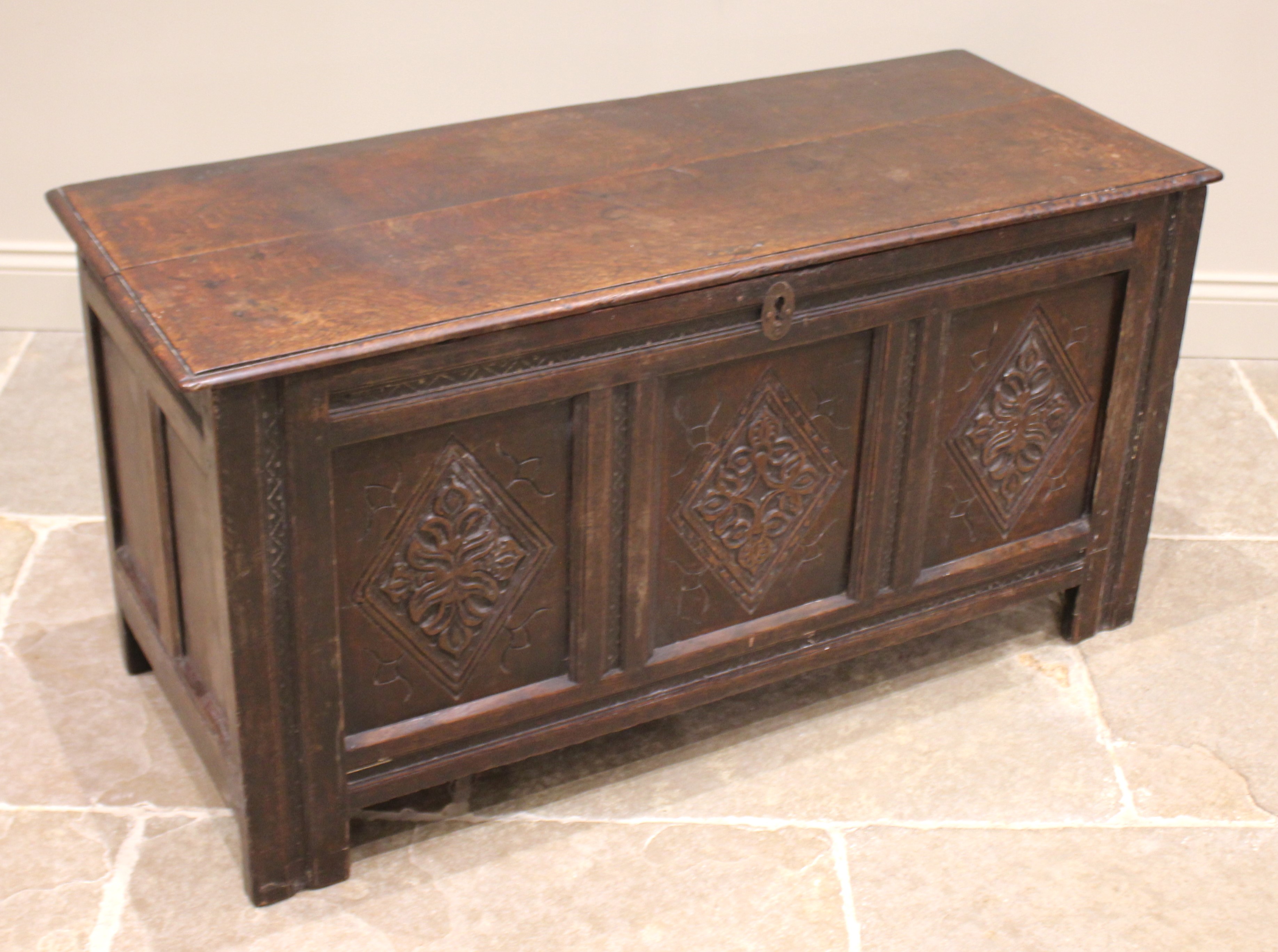 An 18th century oak coffer, the moulded two plank top with carved serrated banding, opening to a - Image 2 of 2