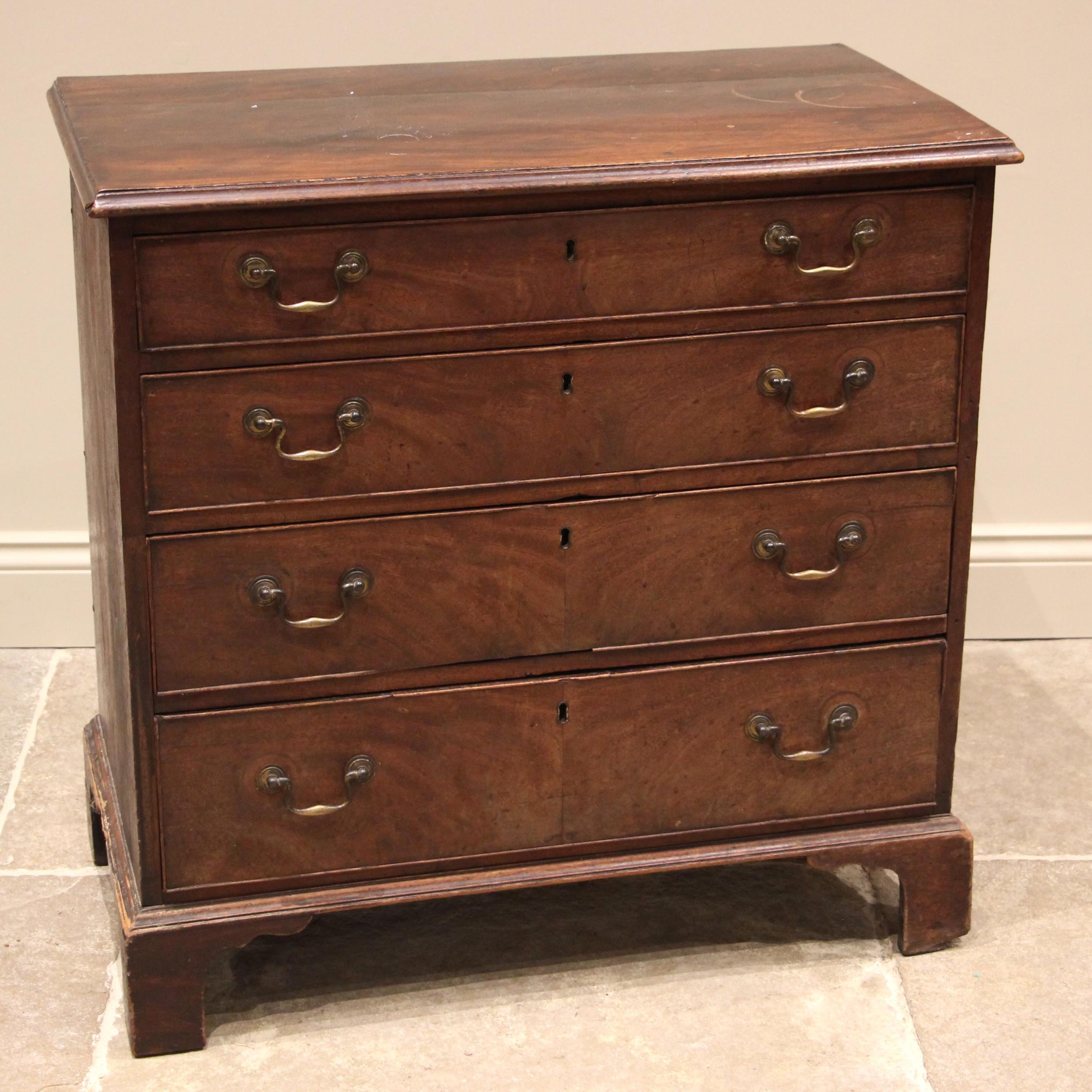 A George III mahogany chest of drawers, the moulded top over four graduated and cock beaded long