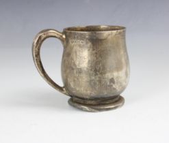 A George VI silver mug, James R Ogden and Sons Ltd, Birmingham 1939, of bulbous form, upon spreading