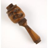 A treen novelty nut cracker, late 19th/early 20th century, the front carved with a face, geometric