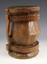 A wooden mortar or vessel, 19th century, of barrel form, the body with carved geometric decoration