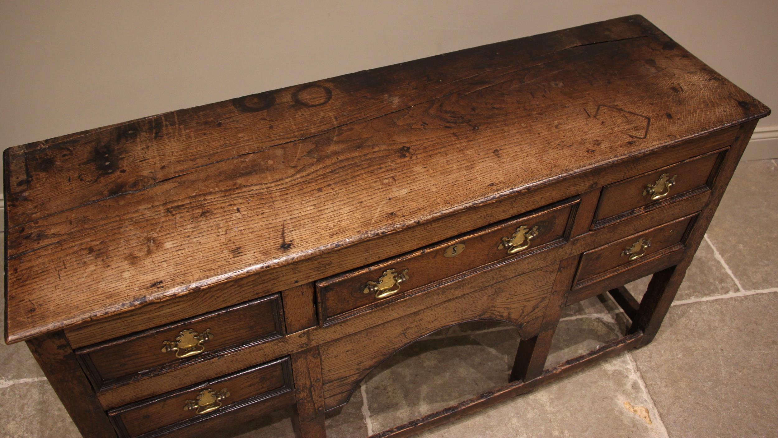 An 18th century oak dresser, the open plate rack with a moulded cornice and plain frieze over - Image 2 of 5
