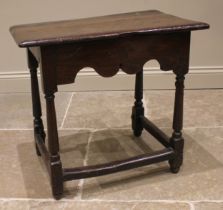 A 17th century Welsh oak side table, the moulded plank top upon tapering cylindrical and block