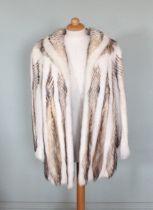 A white mink herringbone three quarter length coat, by Stoumbos furs, lined, approx a UK size 12,