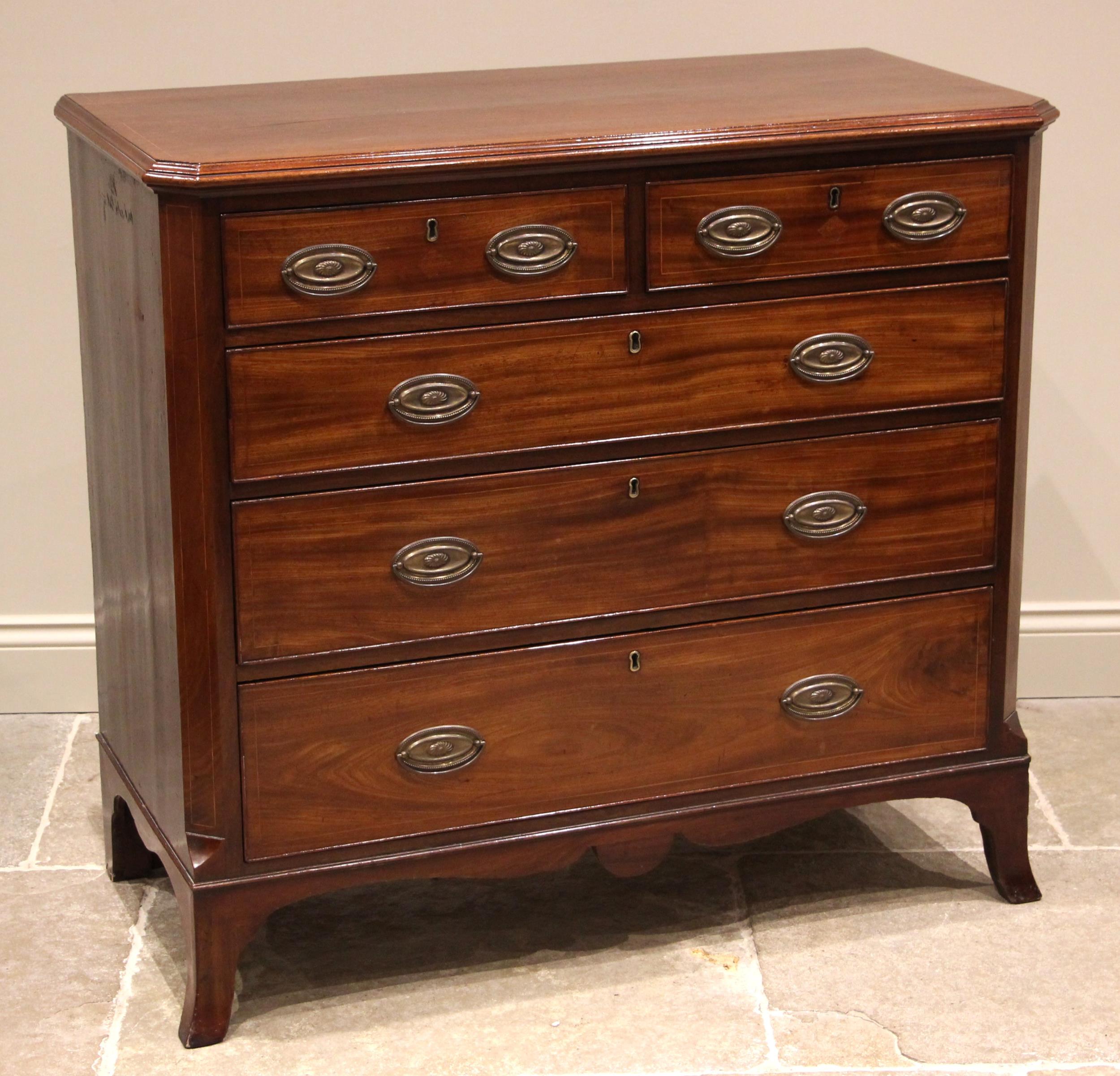 An early 19th century mahogany chest of drawers, the rectangular moulded top with canted front
