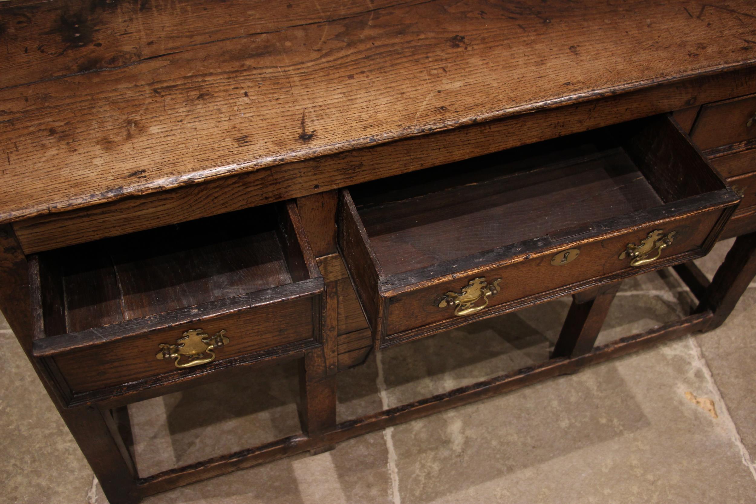 An 18th century oak dresser, the open plate rack with a moulded cornice and plain frieze over - Image 3 of 5