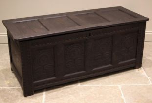 A late 17th/early 18th century oak coffer, the four panel hinged cover above a nulled frieze and