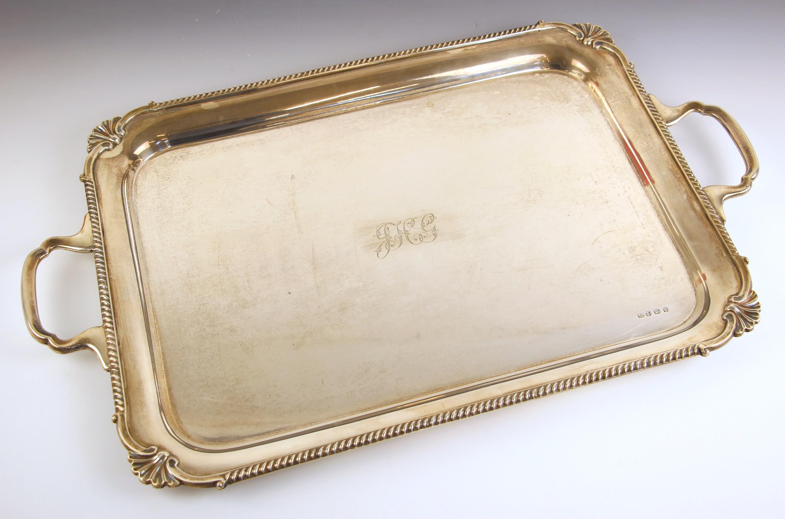 A George V silver tray, L Harrison, Sheffield 1931, the shaped twin handled tray with shell shaped