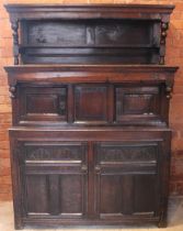 A Welsh joined oak cwpwrdd tridarn, early 18th century, the upper tier with a panel back and