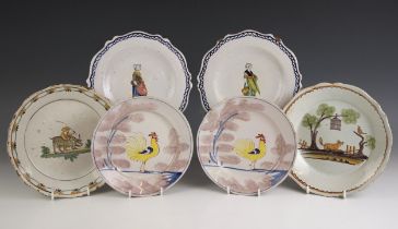 A near pair of Bristol Delft 'Farmyard' plates, circa 1730, each polychrome decorated with a